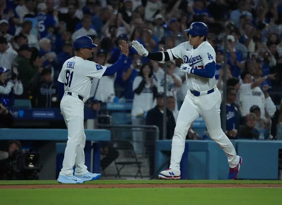 Jun 16, 2026; Los Angeles, California, USA; Los Angeles Dodgers designated hitter Shohei Ohtani (17) high-fives third base coach Dino Ebel (91) after hitting a home run during the sixth inning against the Tampa Bay Rays at Dodger Stadium. Mandatory Credit: Kirby Lee-Imagn Images