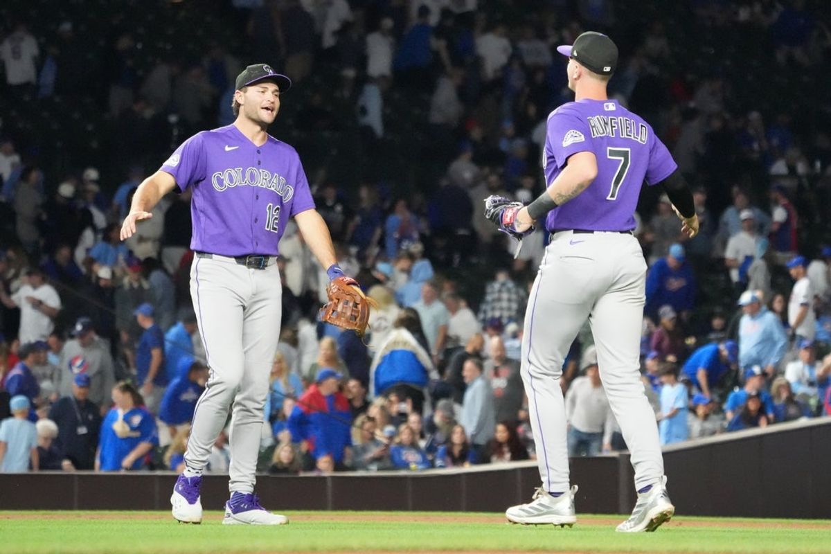 Jun 16, 2026; Chicago, Illinois, USA; Colorado Rockies first baseman TJ Rumfield (7) and third baseman Kyle Karros (12) celebrate their win against the Chicago Cubs at Wrigley Field. Mandatory Credit: David Banks-Imagn Images