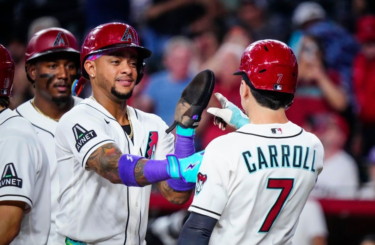Diamondbacks outfielder Corbin Carroll (7) and Ketel Marte (L) celebrate a Carroll grand-slam against the Angels during a game at Chase Field in Phoenix, Ariz. on June 17, 2026.