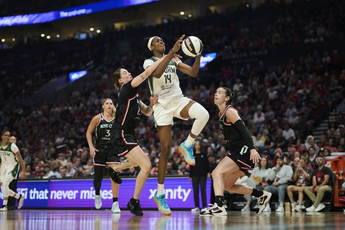 Jun 17, 2026; Portland, Oregon, USA; Seattle Storm center Dominique Malonga (14) is fouled by Portland Fire forward Emily Engstler (21) during the first half at Moda Center. Mandatory Credit: Troy Wayrynen-Imagn Images