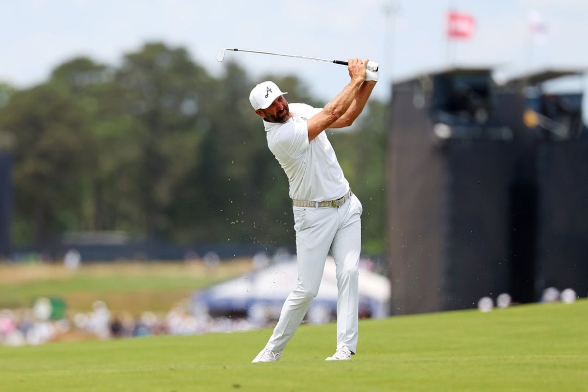 Jun 19, 2026; Southampton, New York, USA; Dustin Johnson makes his play on the 18th fairway during the second round of the U.S. Open golf tournament at Shinnecock Hills Golf Club. Mandatory Credit: Bill Streicher-Imagn Images