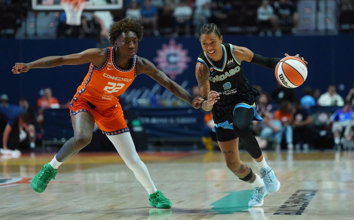 Jun 22, 2026; Uncasville, Connecticut, USA; Chicago Sky guard Natasha Cloud (9) drives the ball against Connecticut Sun guard Saniya Rivers (22) in the first half at Mohegan Sun Arena. Mandatory Credit: David Butler II-Imagn Images