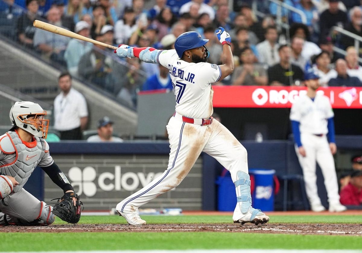 22 de junho de 2026; Toronto, Ontário, CAN; O jogador de primeira base do Toronto Blue Jays, Vladimir Guerrero Jr. (27), acerta uma bola de sacrifício marcando uma corrida contra o Houston Astros durante a quarta entrada no Rogers Centre. Crédito obrigatório: Nick Turchiaro-Imagn Images