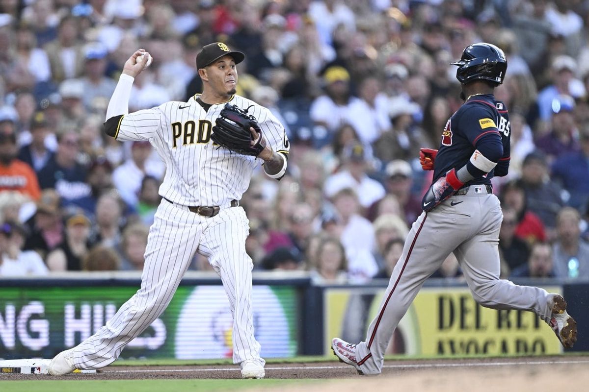 Jun 24, 2026; San Diego, California, USA; San Diego Padres third baseman Manny Machado (13) throws to second base after getting the force out at third on Atlanta Braves second baseman Ozzie Albies (1) during the fourth inning at Petco Park. Mandatory Credit: Denis Poroy-Imagn Images