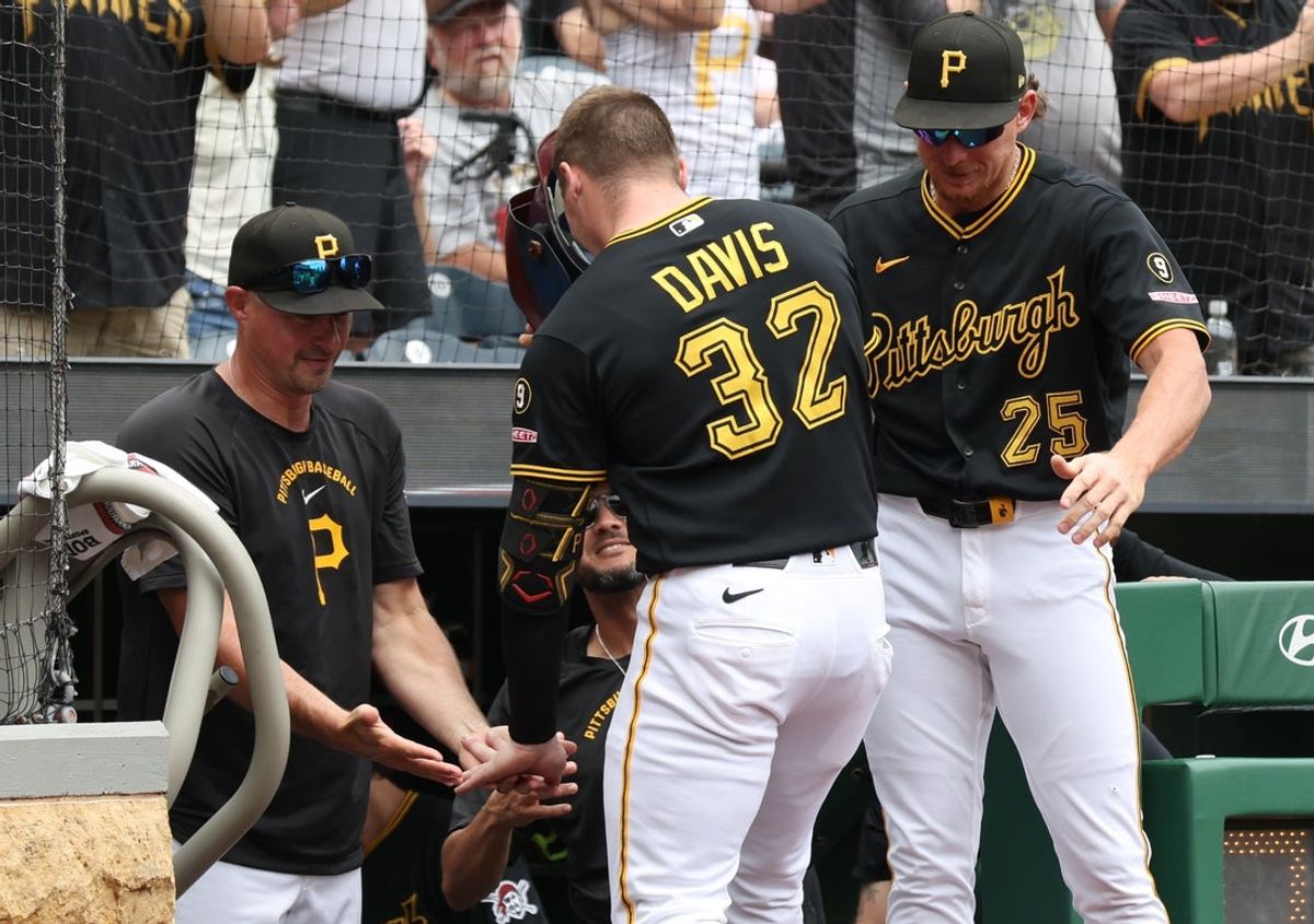 Jun 25, 2026; Pittsburgh, Pennsylvania, USA;  Pittsburgh Pirates manager Don Kelly (left) and outfielder Billy Cook (25) greet catcher Henry Davis (32) returning to the dugout after hitting a two run home run against the Seattle Mariners during the third inning at PNC Park. Mandatory Credit: Charles LeClaire-Imagn Images