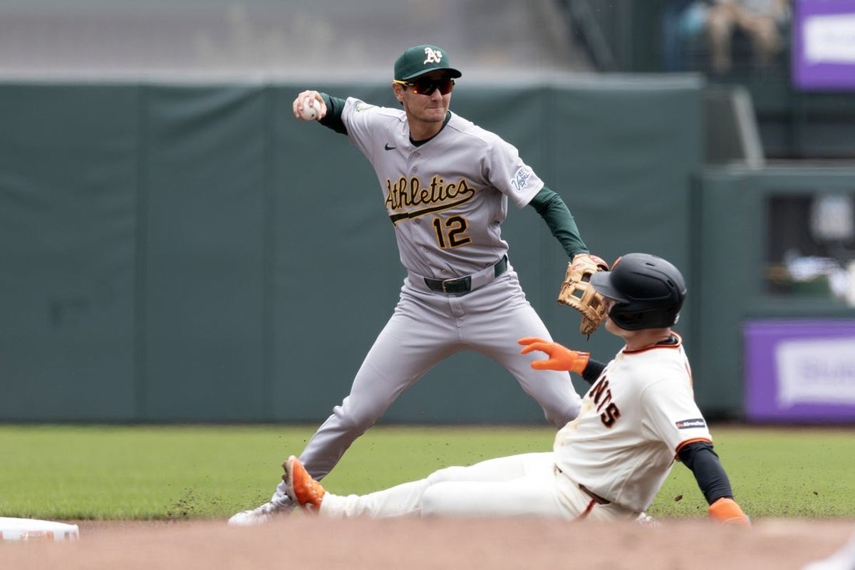 Jun 25, 2026; San Francisco, California, USA; Athletics shortstop Alika Williams (12) forces out San Francisco Giants third baseman Matt Chapman (26) on a fielder’s choice during the first inning at Oracle Park. Mandatory Credit: D. Ross Cameron-Imagn Images