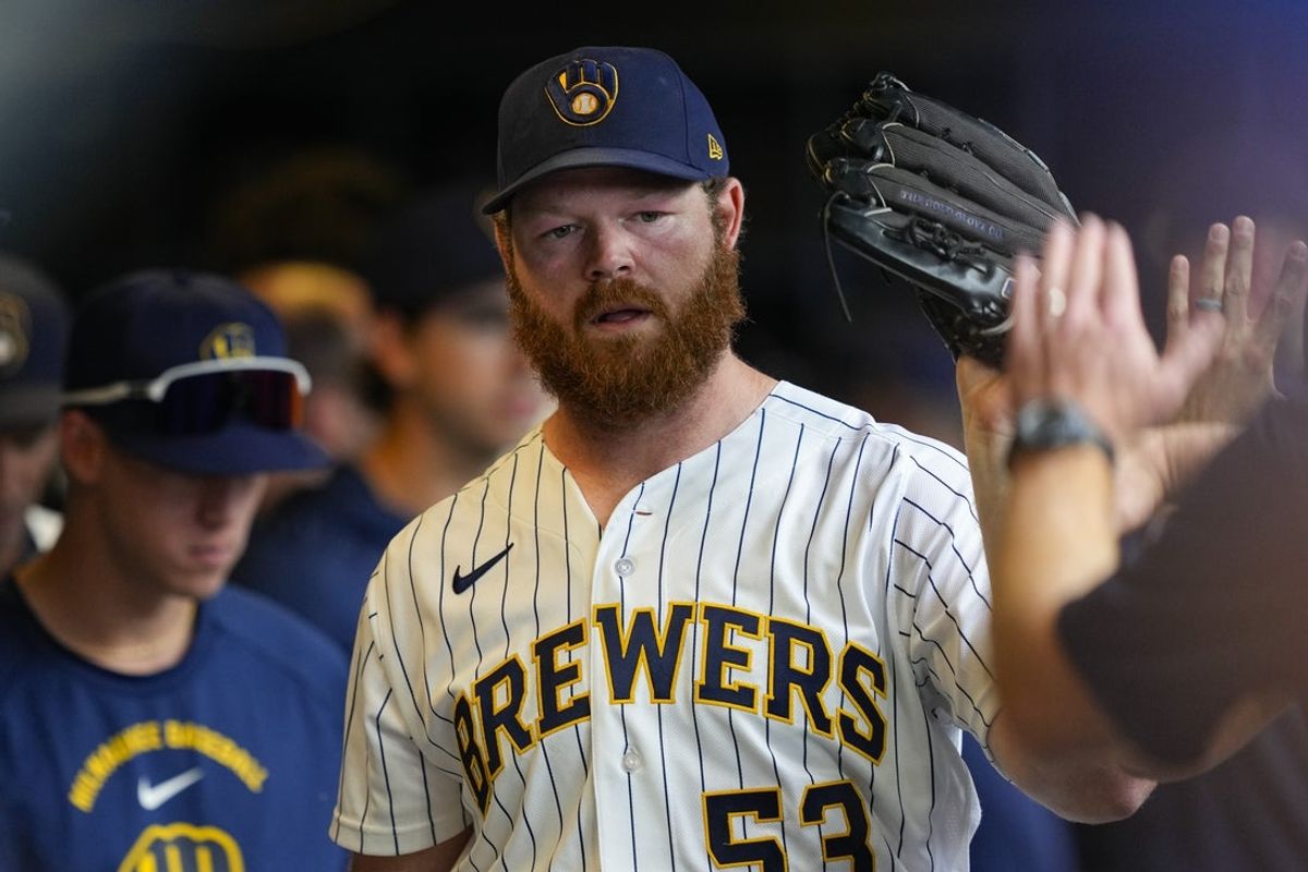 Jun 28, 2026; Milwaukee, Wisconsin, USA;  Milwaukee Brewers pitcher Brandon Woodruff (53) high fives teammates in the dugout during the sixth inning against the Chicago Cubs at American Family Field. Mandatory Credit: Jeff Hanisch-Imagn Images
