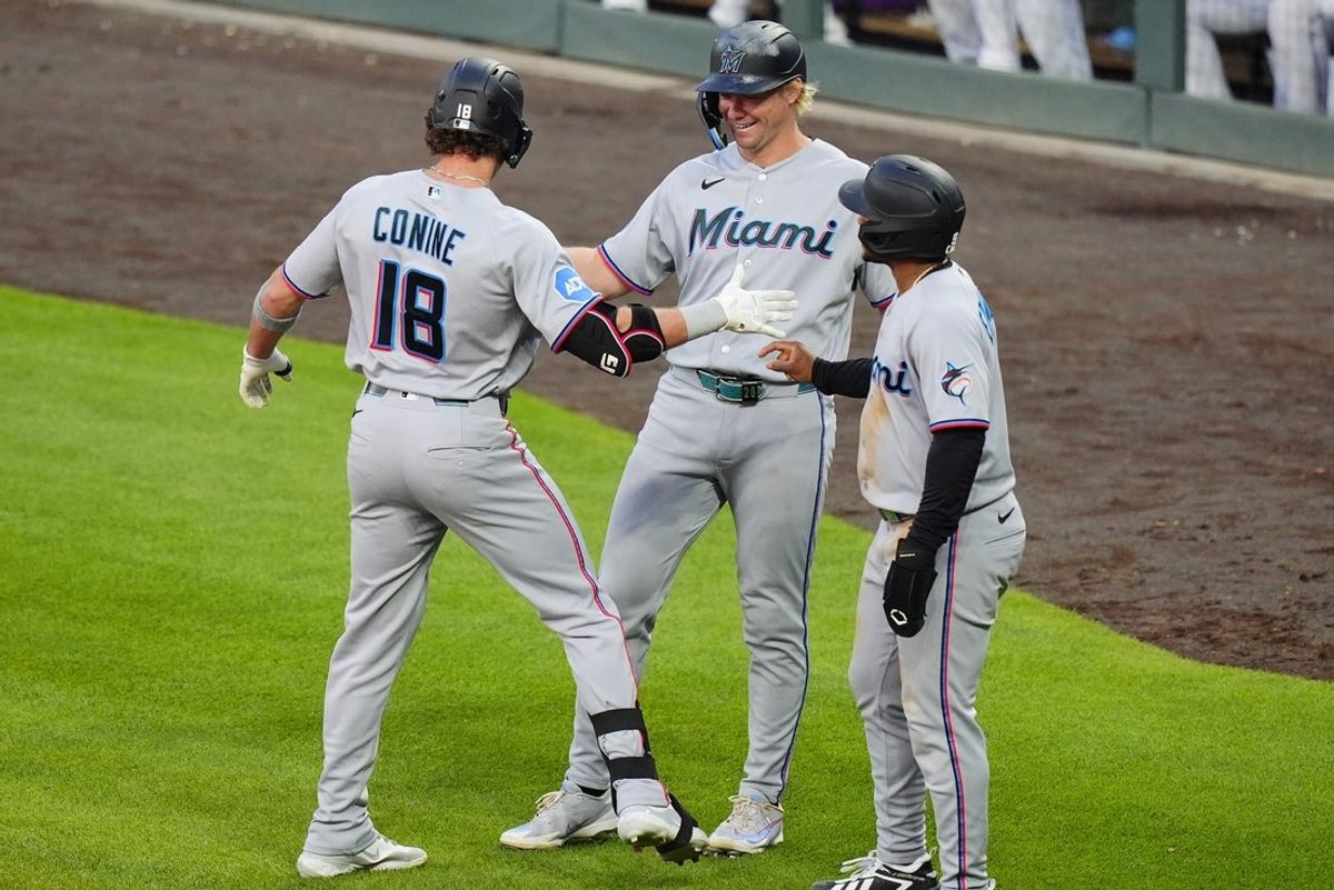 Jun 29, 2026; Denver, Colorado, USA; Miami Marlins pinch hitter Griffin Conine (18) celebrates his three-run home run with first  baseman Kyle Stowers (28) and second baseman Xavier Edwards (9) in the fifth inning against the Colorado Rockies at Coors Field. Mandatory Credit: Ron Chenoy-Imagn Images