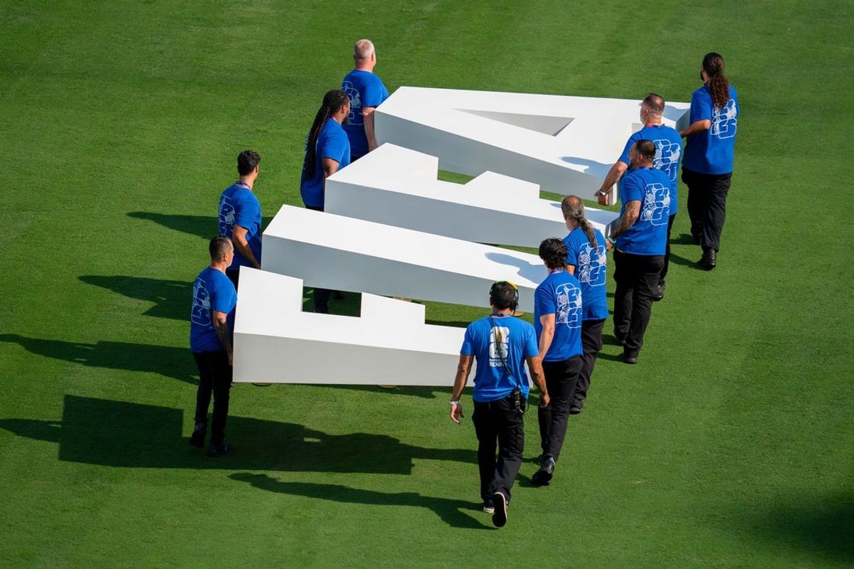 People carry “FIFA” letters on to the field before a 2026 FIFA World Cup round of 32 match between France and Sweden at New York New Jersey Stadium on Tuesday, June 30, 2026, in East Rutherford, NJ.