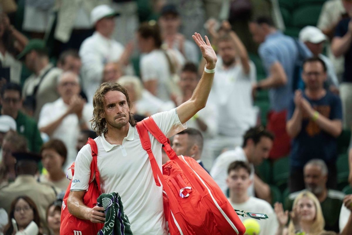 Jul 1, 2026; London, United Kingdom; Stefanos Tsitsipas of Greece waves as he leaves the court after losing his match against Novak Djokovic of Serbia on day three at All England Lawn Tennis and Croquet Club.  Mandatory Credit: Susan Mullane-Imagn Images