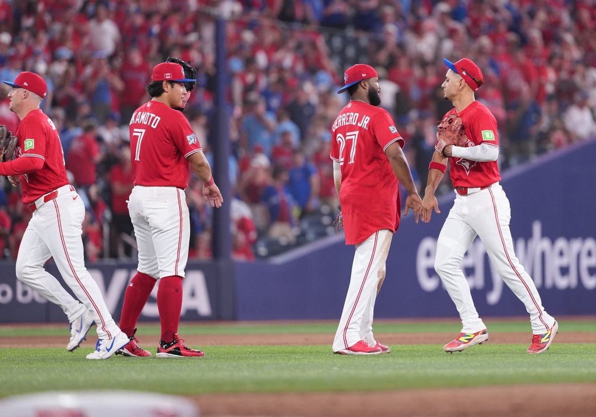 Jul 1, 2026; Toronto, Ontario, CAN; Toronto Blue Jays first baseman Vladimir Guerrero Jr. (27) celebrates the win with shortstop Andres Gimenez (0) against the New York Mets at the end of the ninth inning at Rogers Centre. Mandatory Credit: Nick Turchiaro-Imagn Images