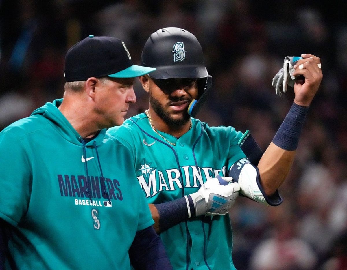 Seattle Mariners center fielder Julio Rodriguez talks to manager Dan Wilson after being hit by a pitch during a Major League Baseball game against the Cleveland Guardians on June 27, 2026, at Progressive Field in Cleveland. The Guardians won, 4-3.