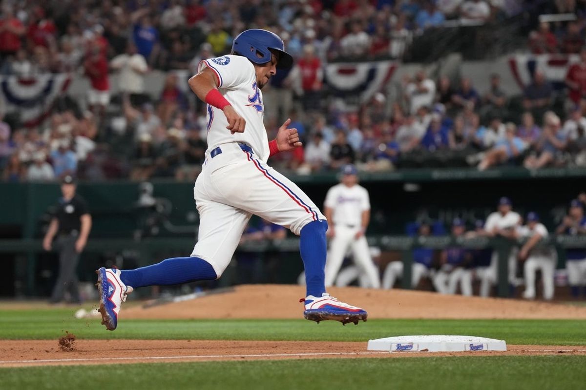 Jul 2, 2026; Arlington, Texas, USA;  Texas Rangers second baseman Nicky Lopez (33) rounds third base to come around to score against the Detroit Tigers during the fourth inning at Globe Life Field. Mandatory Credit: Raymond Carlin III-Imagn Images