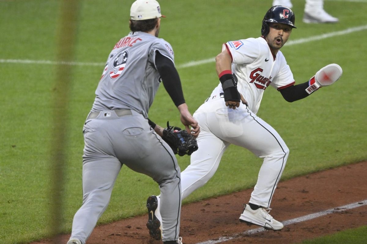 Jul 4, 2026; Cleveland, Ohio, USA; Cleveland Guardians center fielder Steven Kwan (38) runs from Chicago White Sox starting pitcher Sean Burke (59) before being tagged out in the fifth inning at Progressive Field. Mandatory Credit: David Richard-Imagn Images