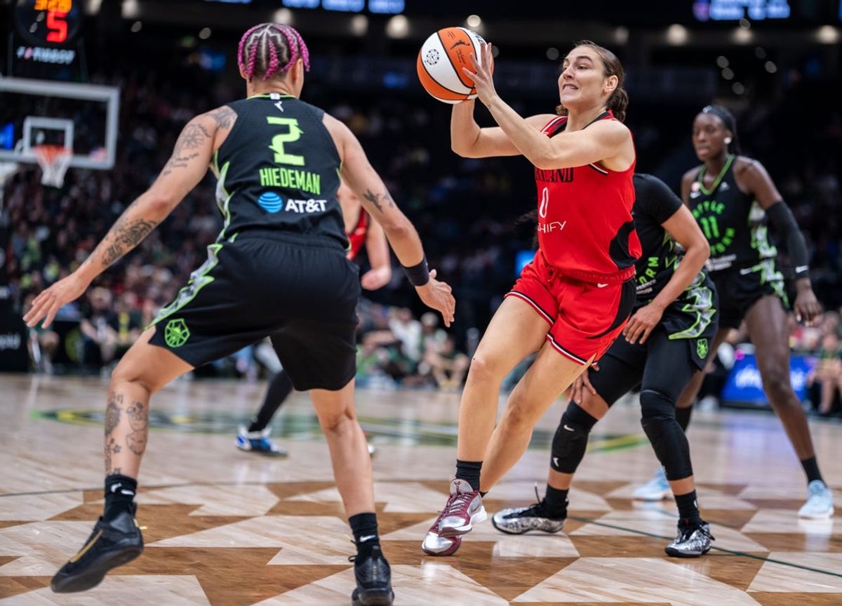 Jul 4, 2026; Seattle, Washington, USA;  Portland Fire guard Carla Leite (0) passes the ball against Seattle Storm guard Natisha Hiedeman (2) during the second half at Climate Pledge Arena. Mandatory Credit: Stephen Brashear-Imagn Images