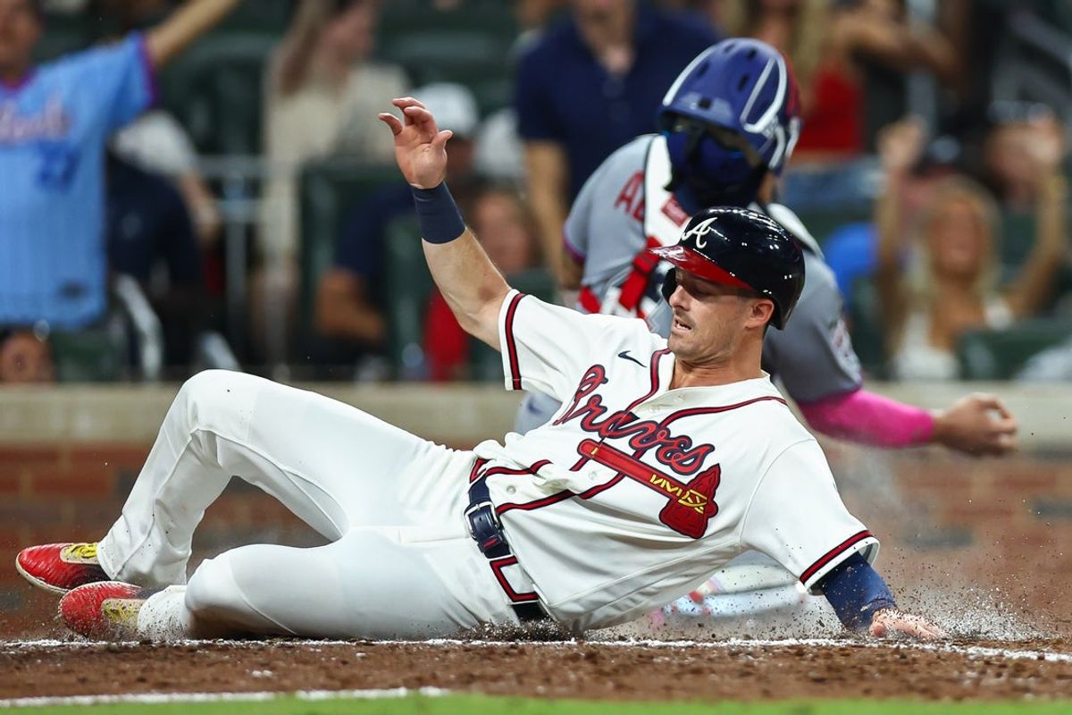 Jul 4, 2026; Cumberland, Georgia, USA; Atlanta Braves left fielder Mike Yastrzemski (18) slides home safely against the New York Mets in the sixth inning at Truist Park. Mandatory Credit: Colin Hubbard-Imagn Images