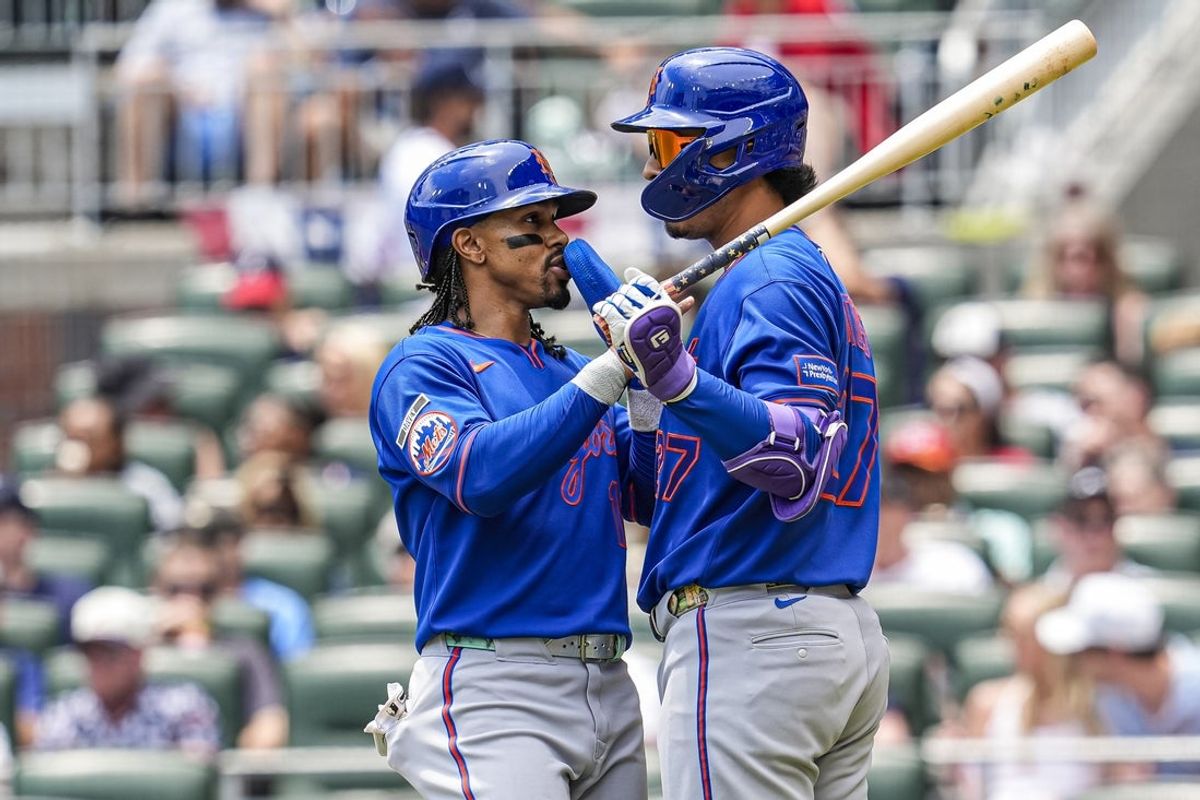 Jul 5, 2026; Cumberland, Georgia, USA; New York Mets shortstop Francisco Lindor (12) reacts with first baseman Mark Vientos (27) after scoring a run against the Atlanta Braves during the first inning at Truist Park. Mandatory Credit: Dale Zanine-Imagn Images