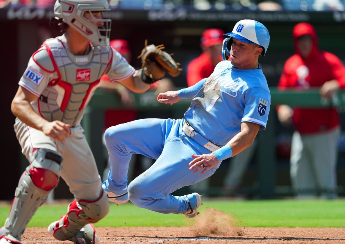 Jul 5, 2026; Kansas City, Missouri, USA; Kansas City Royals left fielder Isaac Collins (1) slides into home to score a run against Philadelphia Phillies catcher Garrett Stubbs (21) during the fifth inning at Kauffman Stadium. Mandatory Credit: Jay Biggerstaff-Imagn Images