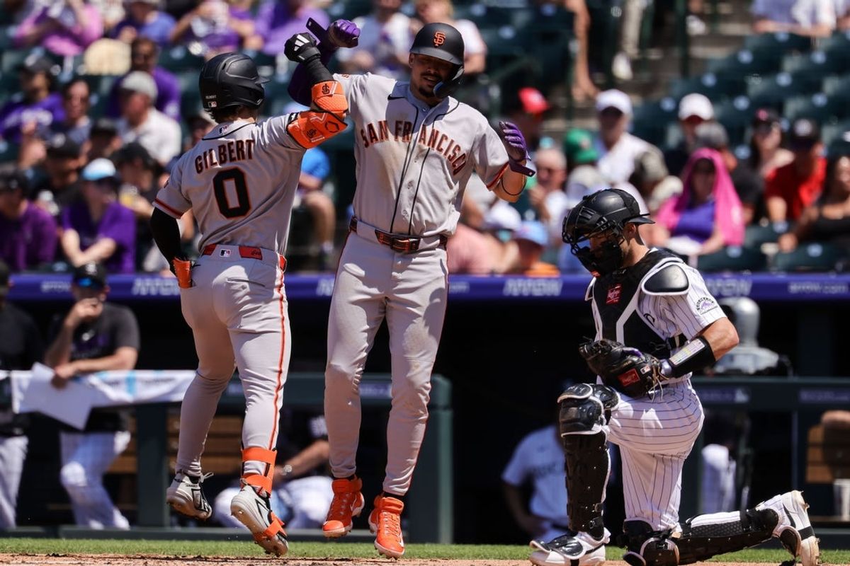 Jul 5, 2026; Denver, Colorado, USA; San Francisco Giants center fielder Drew Gilbert (0) celebrates his two run home run with shortstop Willy Adames (2) as Colorado Rockies catcher Brett Sullivan (26) looks on in the second inning at Coors Field. Mandatory Credit: Isaiah J. Downing-Imagn Images