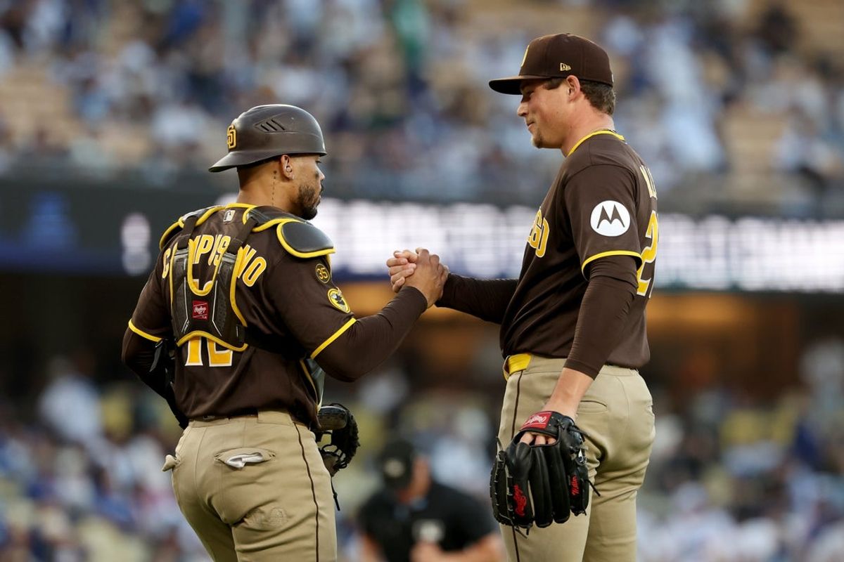 Jul 5, 2026; Los Angeles, California, USA; San Diego Padres catcher Luis Campusano (12) congratulates pitcher Mason Miller (22) after their win against the Los Angeles Dodgers at Dodger Stadium. Mandatory Credit: Kiyoshi Mio-Imagn Images