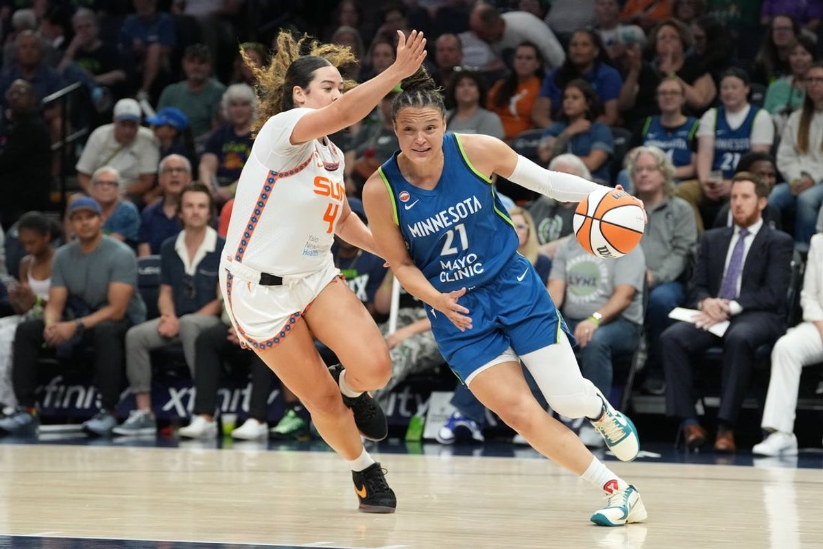 Jul 6, 2026; Minneapolis, Minnesota, USA; Minnesota Lynx guard Kayla McBride (21) drives to the basket past Connecticut Sun guard Charlisse Leger-Walker (4) in the first half at Target Center. Mandatory Credit: Jesse Johnson-Imagn Images