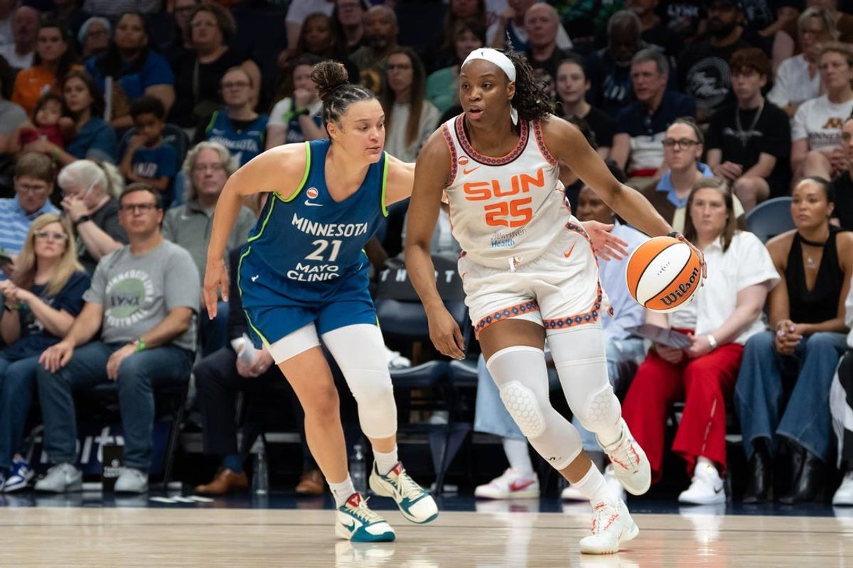Jul 6, 2026; Minneapolis, Minnesota, USA; Connecticut Sun guard Kennedy Burke (25) drives to the basket past Minnesota Lynx guard Kayla McBride (21) in the second half at Target Center. Mandatory Credit: Jesse Johnson-Imagn Images