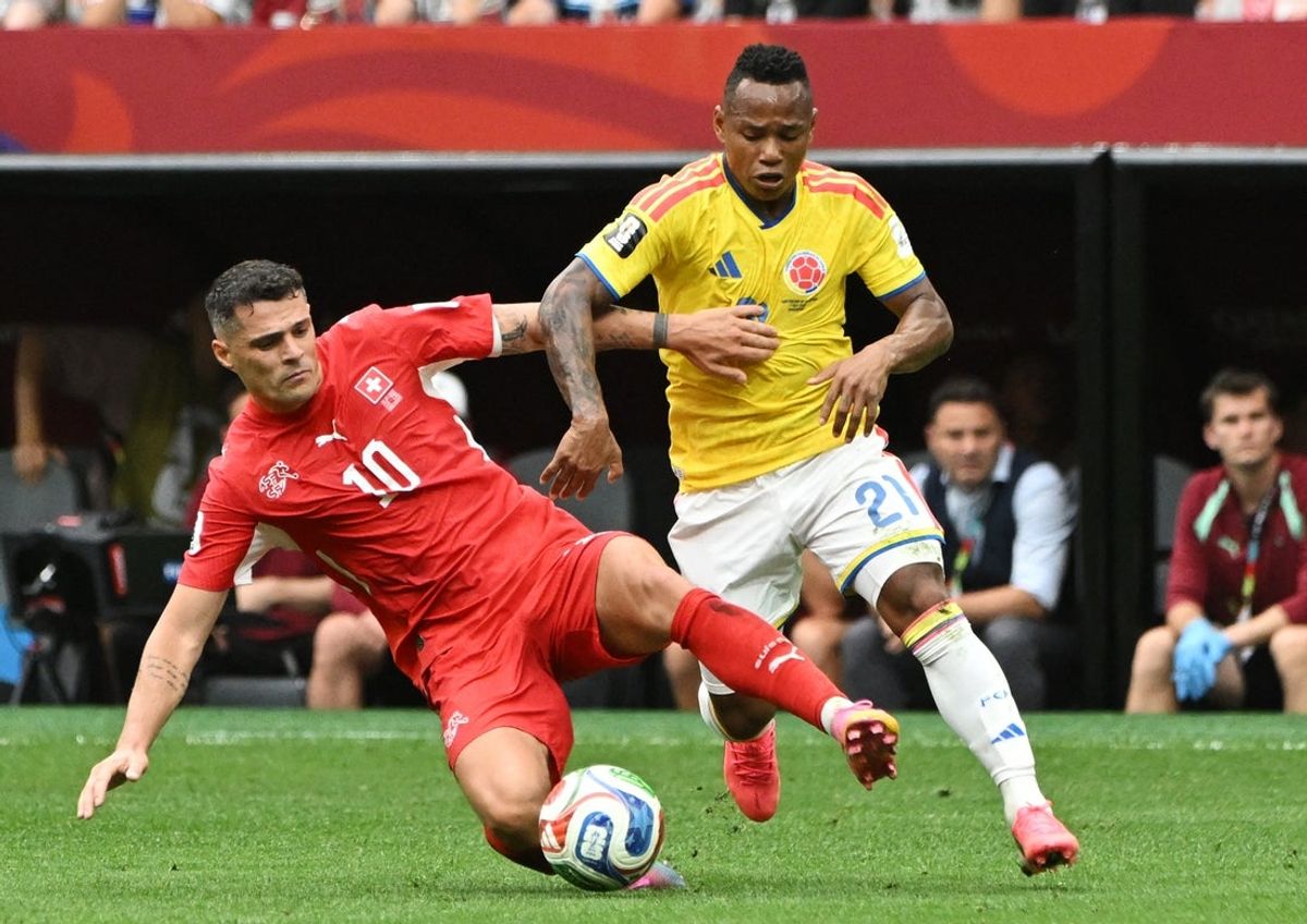 July 7, 2026; Vancouver, Canada; Colombia's Jaminton Campaz in action with Switzerland's Granit Xhaka.  Mandatory Credit: Simon Fearn-Imagn Images
