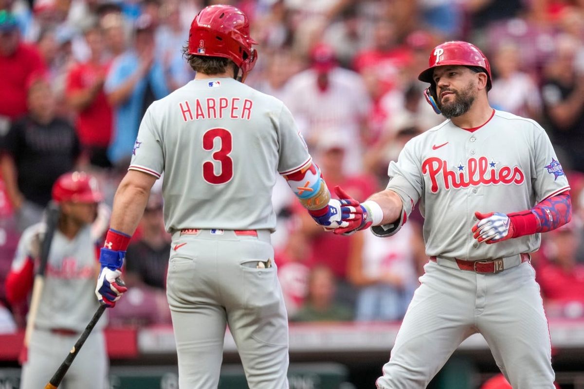 Phillies slugger Kyle Schwarber celebrates with teammate Bryce Harper after hitting a home run.