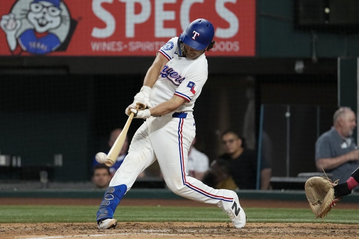 Jul 7, 2026; Arlington, Texas, USA; Texas Rangers shortstop Josh Smith (8) singles against the Los Angeles Angels during the eighth inning at Globe Life Field. Mandatory Credit: Jim Cowsert-Imagn Images