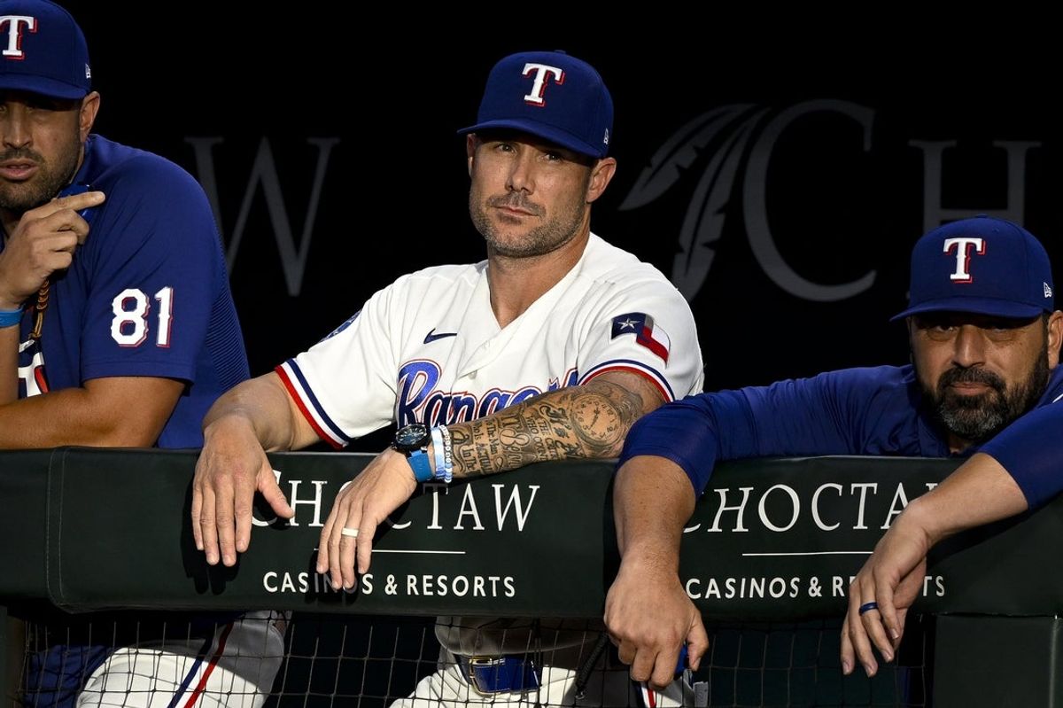 Jul 8, 2026; Arlington, Texas, USA; Texas Rangers manager Skip Schumaker looks on from the dugout during the second inning against the Los Angeles Angels at Globe Life Field. Mandatory Credit: Jerome Miron-Imagn Images