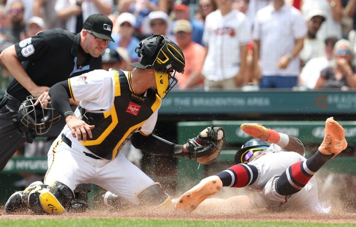 Jul 9, 2026; Pittsburgh, Pennsylvania, USA;  Atlanta Braves center fielder Michael Harris II (23) slides past Pittsburgh Pirates catcher Rafael Flores (43) to score a run during the third inning at PNC Park. Mandatory Credit: Charles LeClaire-Imagn Images