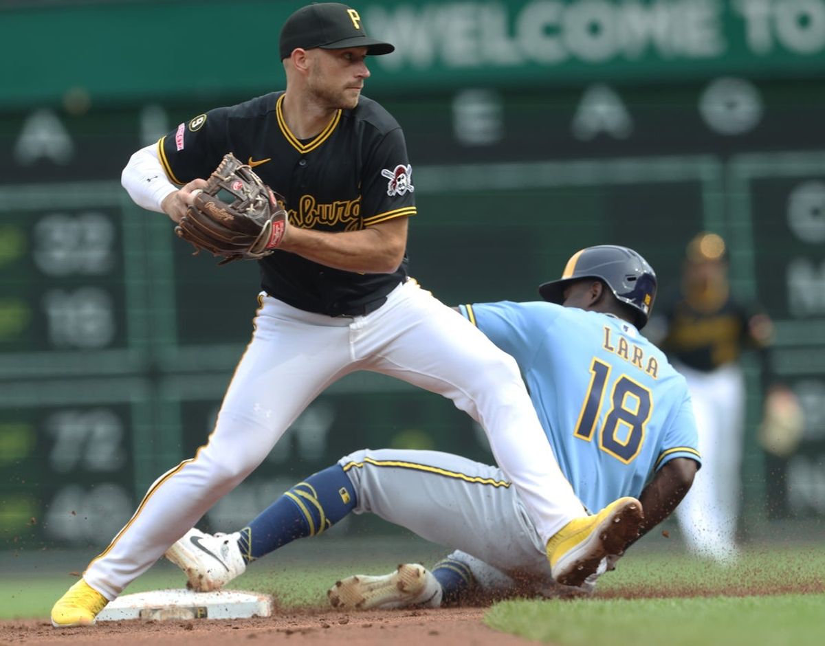 Jul 11, 2026; Pittsburgh, Pennsylvania, USA;  Pittsburgh Pirates second baseman Brandon Lowe (5) throws to first base to turn a double play over Milwaukee Brewers right  fielder Luis Lara (18) during the second inning at PNC Park. Mandatory Credit: Charles LeClaire-Imagn Images