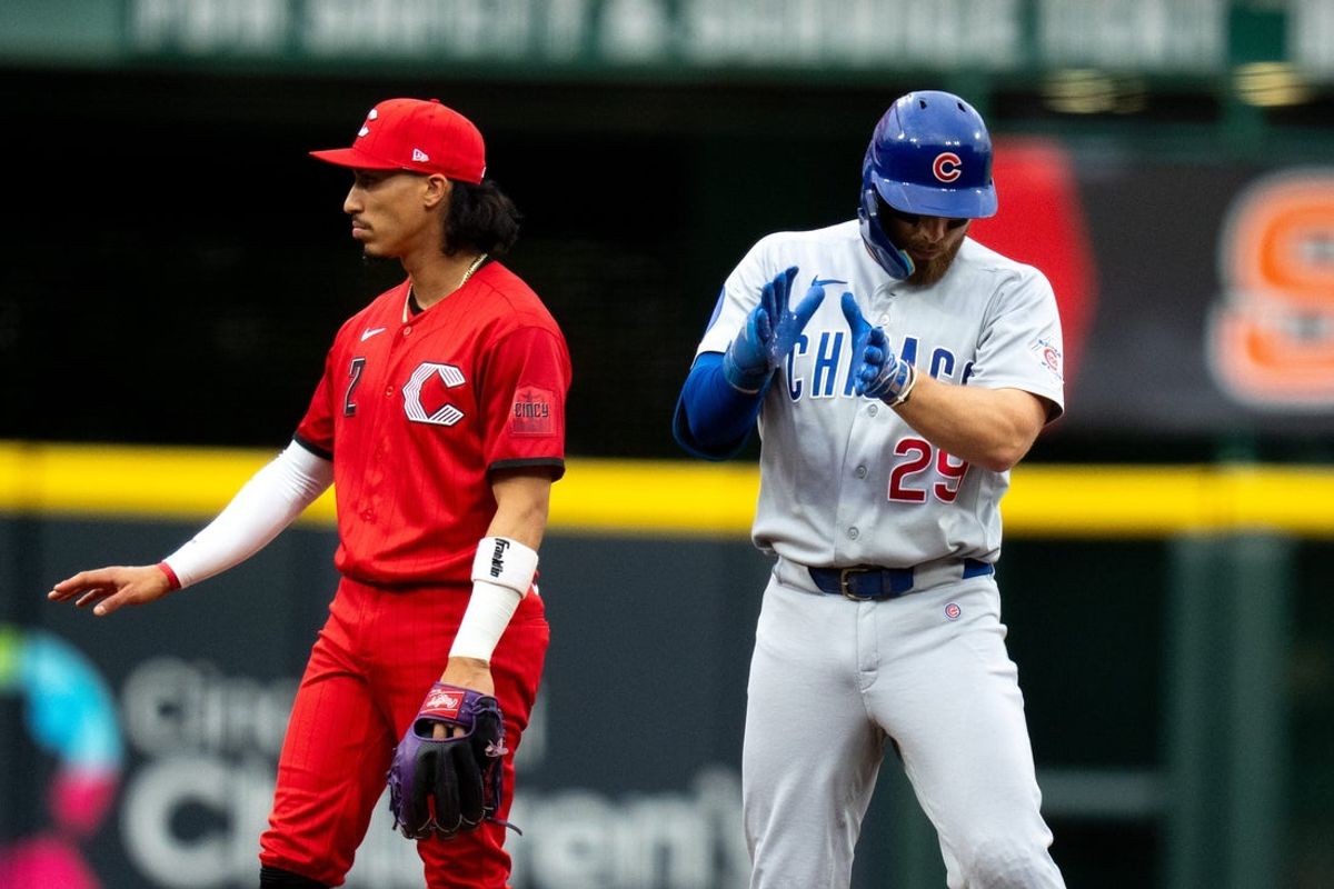 Chicago Cubs first baseman Michael Busch (29) and Cincinnati Reds second baseman Edwin Arroyo (2) react qs he reaches second on a double in the second inning between the Chicago Cubs and Cincinnati Reds at Great American Ball Park in Cincinnati on Saturday, July 11, 2026.