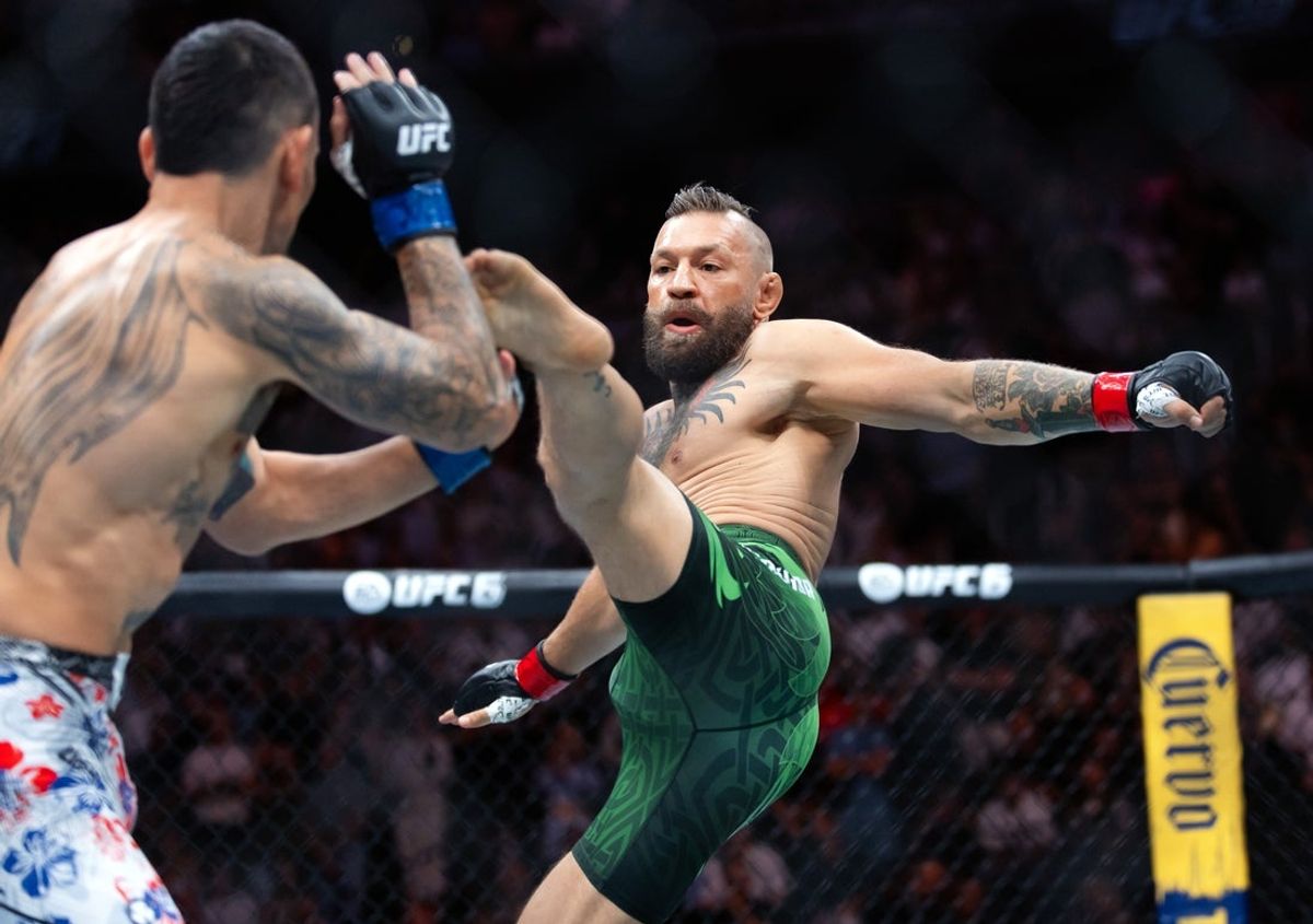 Jul 11, 2026; Las Vegas, Nevada, USA; Conor McGregor (right) attempts a flying kick at the start of his fight against Max Holloway during UFC 329 at T-Mobile Arena. Mandatory Credit: Mark J. Rebilas-Imagn Images