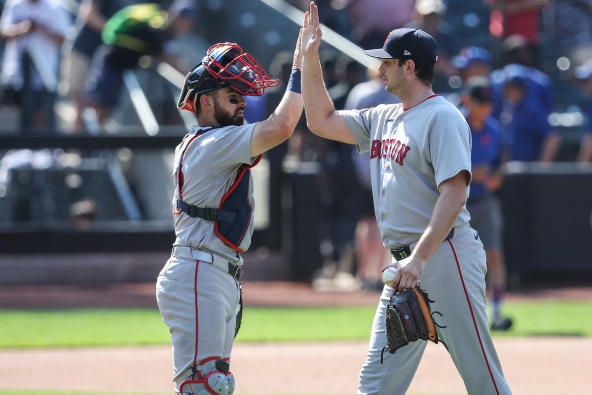 Jul 12, 2026; New York City, New York, USA;  Boston Red Sox catcher Connor Wong (12) and relief pitcher Garrett Whitlock (22) celebrate after defeating the New York Mets 3-2 at Citi Field. Mandatory Credit: Wendell Cruz-Imagn Images