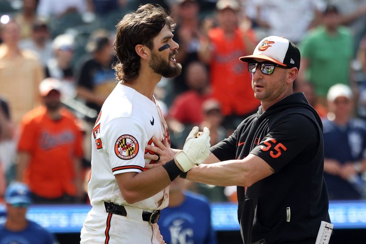 Jul 12, 2026; Baltimore, Maryland, USA; Baltimore Orioles third baseman Blaze Alexander (23) reacts to getting hit by a pitch in front of Baltimore Orioles manager Craig Albernaz during the seventh inning against the Kansas City Royals at Oriole Park at Camden Yards. Mandatory Credit: Daniel Kucin Jr.-Imagn Images