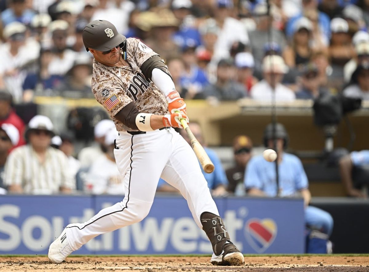 Jul 12, 2026; San Diego, California, USA; San Diego Padres first baseman Ty France (25) hits a single during the second inning against the Toronto Blue Jays at Petco Park. Mandatory Credit: Denis Poroy-Imagn Images