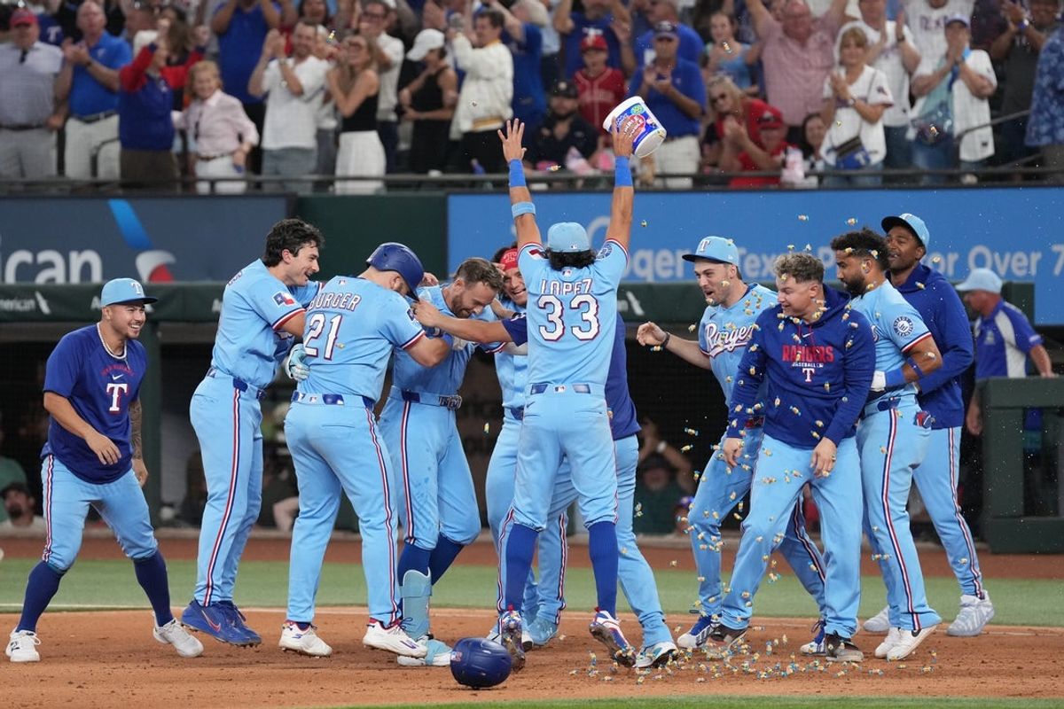 Jul 12, 2026; Arlington, Texas, USA;  Texas Rangers right fielder Brandon Nimmo (24) celebrates with teammates after hitting a walk-off RBI single against the Houston Astros during the ninth inning at Globe Life Field. Mandatory Credit: Raymond Carlin III-Imagn Images