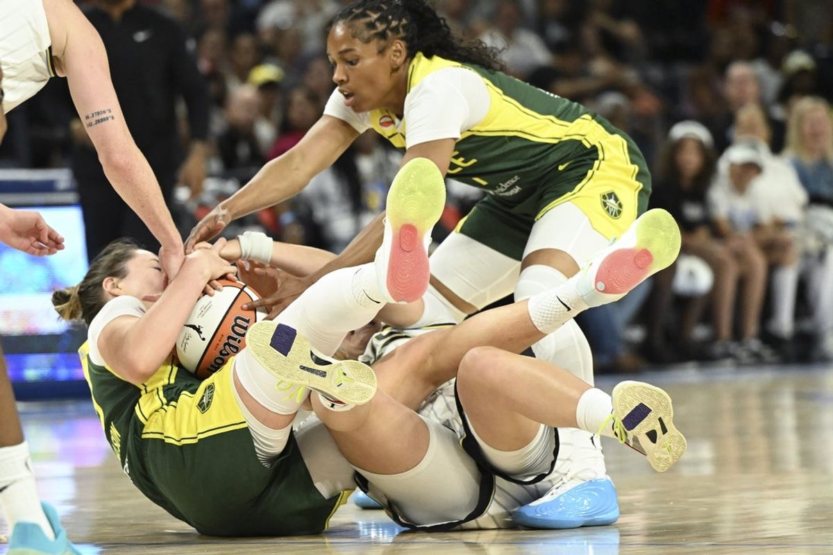 Jul 15, 2026; Chicago, Illinois, USA;   Seattle Storm forward Katie Lou Samuelson (33), left, grabs the ball against the Chicago Sky during the first half at Wintrust Arena. Mandatory Credit: Matt Marton-Imagn Images