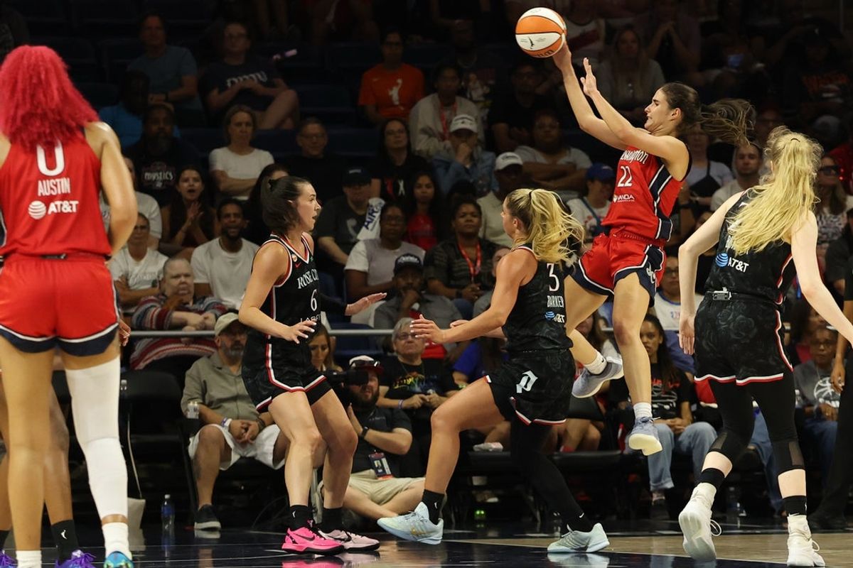 Jul 16, 2026; Washington, District of Columbia, USA; Washington Mystics guard Sonia Citron (22) leaps to pass the ball as Portland Fire forward Bridget Carleton (6) and Fire guard Sarah Ashlee Barker (3) defend in the second half at CareFirst Arena. Mandatory Credit: Geoff Burke-Imagn Images