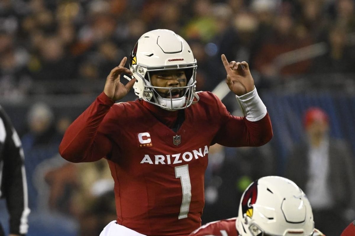 Dec 24, 2023; Chicago, Illinois, USA;  Arizona Cardinals quarterback Kyler Murray (1) signals to his team against the Chicago Bears during the first half at Soldier Field.