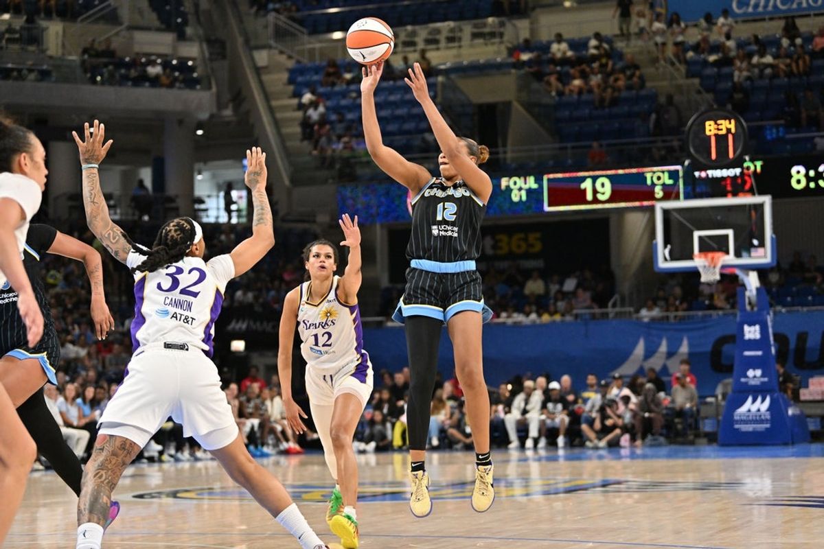 Jul 17, 2026; Chicago, Illinois, USA; Chicago Sky guard Sydney Taylor (12) goes up for a shot against Los Angeles Sparks forward Emma Cannon (32) during the first half at Wintrust Arena. Mandatory Credit: Patrick Gorski-Imagn Images
