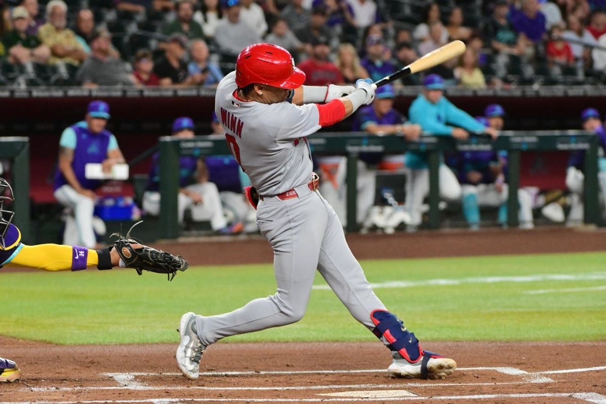 Jul 17, 2026; Phoenix, Arizona, USA; St. Louis Cardinals shortstop Masyn Winn (0) hits a two RBI single in the first inning against the Arizona Diamondbacks at Chase Field. Mandatory Credit: Matt Kartozian-Imagn Images