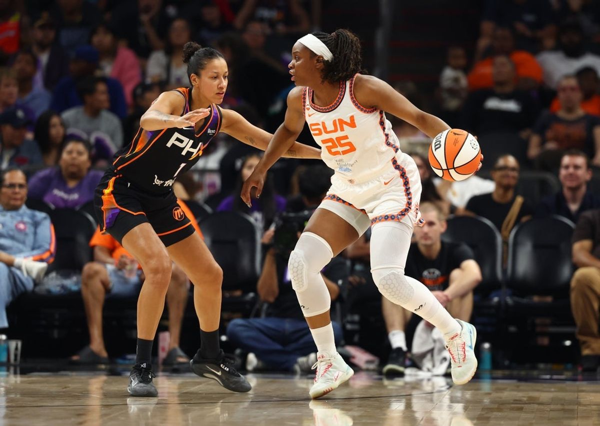 Jul 17, 2026; Phoenix, Arizona, USA; Connecticut Sun guard Kennedy Burke (25) controls the ball against Phoenix Mercury forward Noemie Brochant (1) in the first half at Mortgage Matchup Center. Mandatory Credit: Mark J. Rebilas-Imagn Images