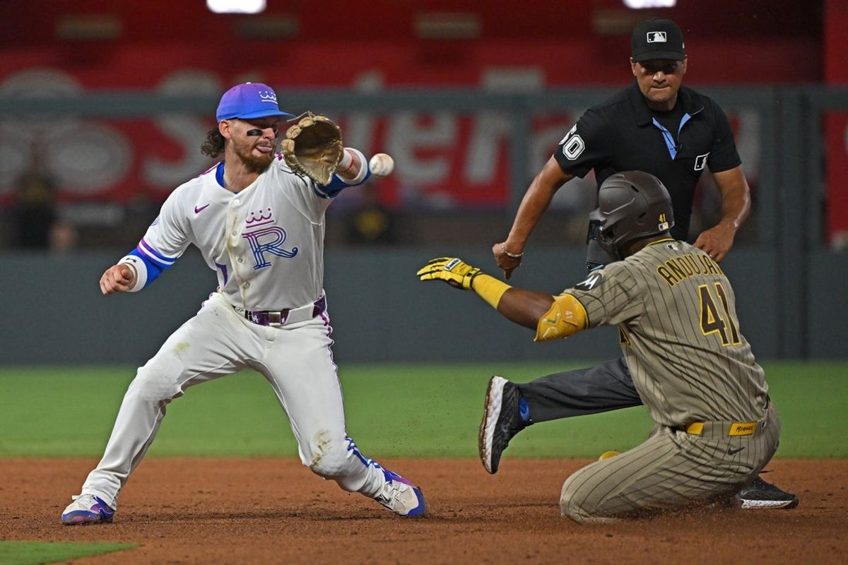 Jul 17, 2026; Kansas City, Missouri, USA;  San Diego Padres designated hitter Miguel Andujar (41) slides into second base with an RBI double against Kansas City Royals shortstop Bobby Witt Jr. (7) in the tenth inning at Kauffman Stadium. Mandatory Credit: Peter Aiken-Imagn Images