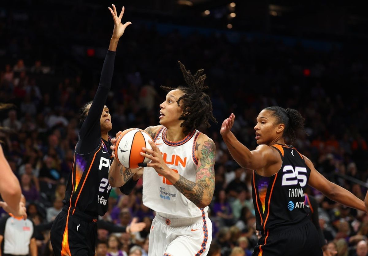 Jul 17, 2026; Phoenix, Arizona, USA; Connecticut Sun center Brittney Griner (42) drives to the basket against Phoenix Mercury forward DeWanna Bonner (24) and Alyssa Thomas (25) in the second half at Mortgage Matchup Center. Mandatory Credit: Mark J. Rebilas-Imagn Images