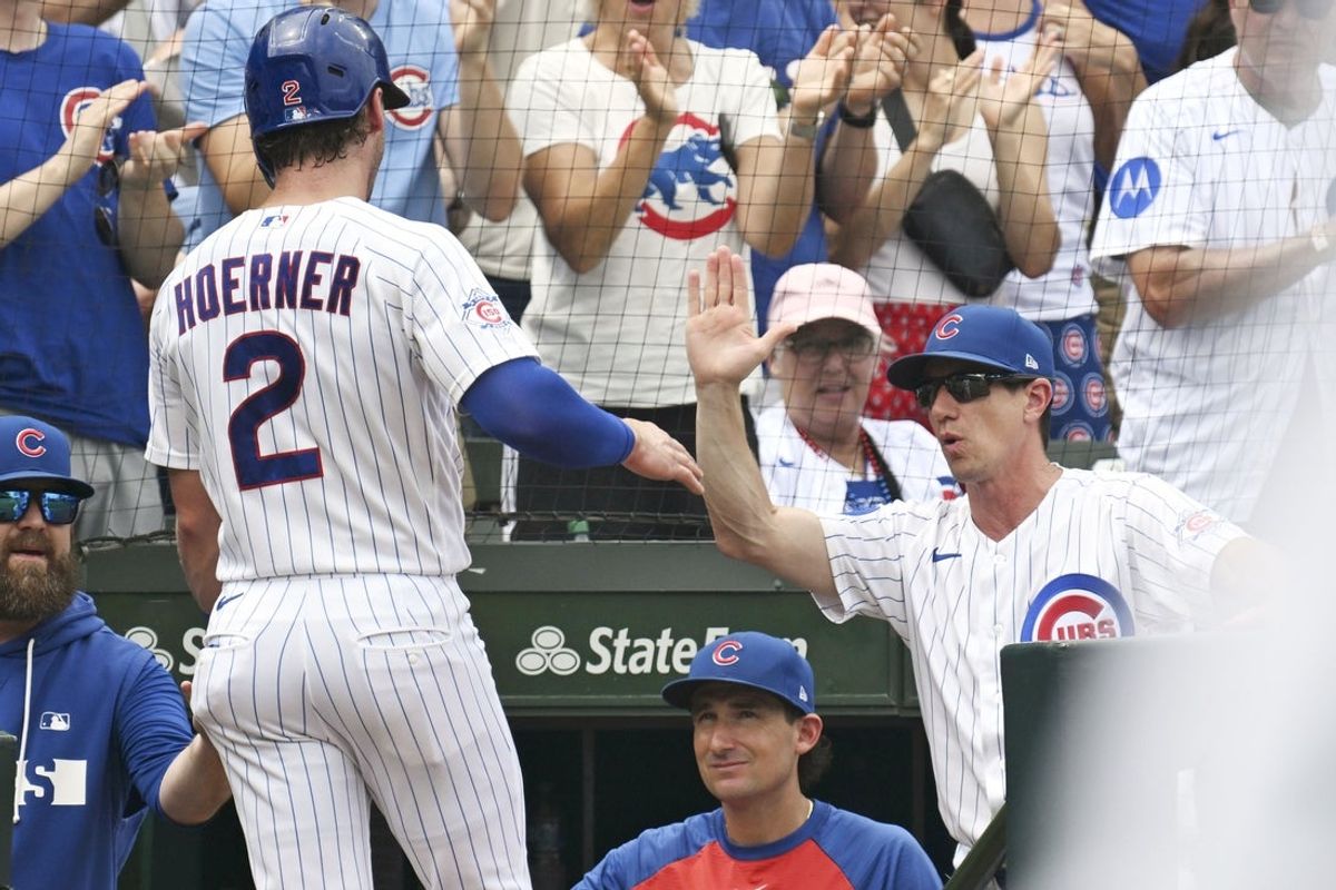 Jul 18, 2026; Chicago, Illinois, USA;  Chicago Cubs second baseman Nico Hoerner high fives Chicago Cubs manager Craig Counsell after scoring against the Minnesota Twins during the second inningat Wrigley Field. Mandatory Credit: Matt Marton-Imagn Images