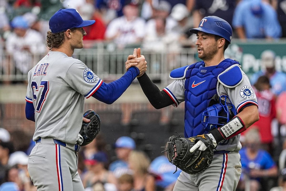Jul 18, 2026; Cumberland, Georgia, USA; Texas Rangers pitcher Jacob Latz (67) reacts with catcher Kyle Higashioka (11) after defeating the Atlanta Braves at Truist Park. Mandatory Credit: Dale Zanine-Imagn Images