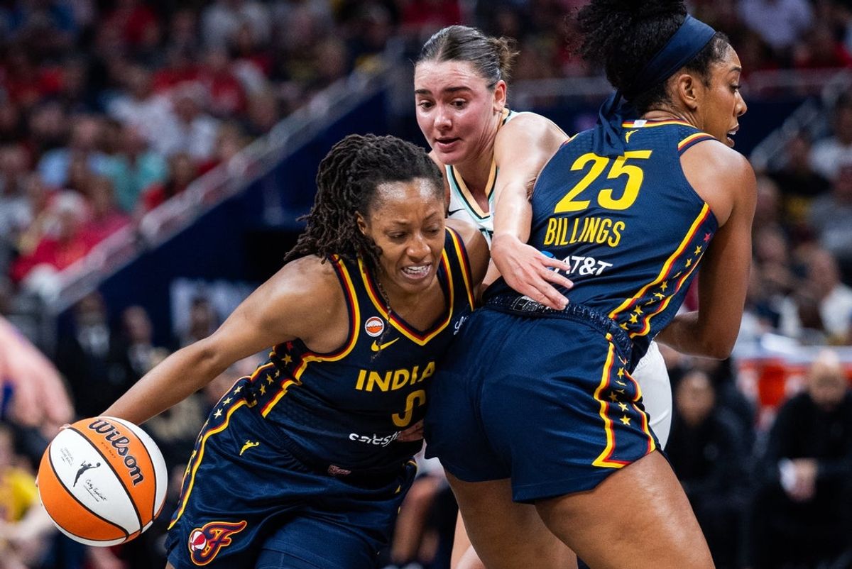 Jul 18, 2026; Indianapolis, Indiana, USA; Indiana Fever guard Kelsey Mitchell (0) dribbles the ball while New York Liberty guard Pauline Astier (18) defends in the first half at Gainbridge Fieldhouse. Mandatory Credit: Trevor Ruszkowski-Imagn Images