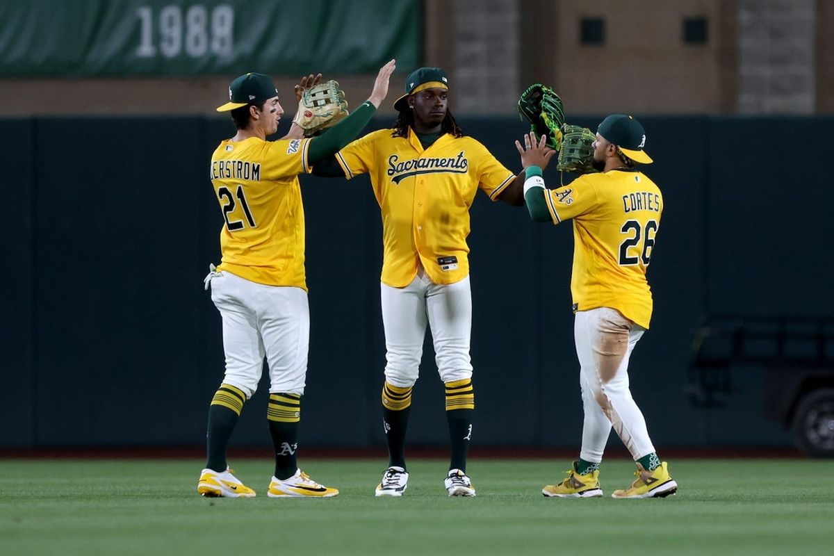 Jul 18, 2026; West Sacramento, California, USA; Athletics outfielders Tyler Soderstron (21), Lawrence Butler (4), and Carlos Cortes (26) celebrate their win against the Washington Nationals at Sutter Health Park. Mandatory Credit: Dennis Lee-Imagn Images